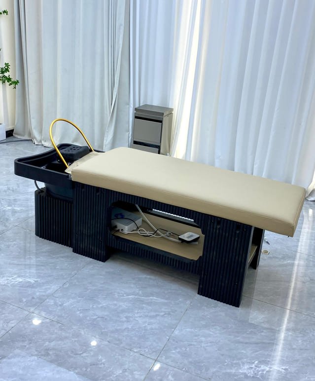 Nuvo Japanese Head Spa Table in sleek black base and basin with a brown table, showing the plumbed basin with the halo ring.